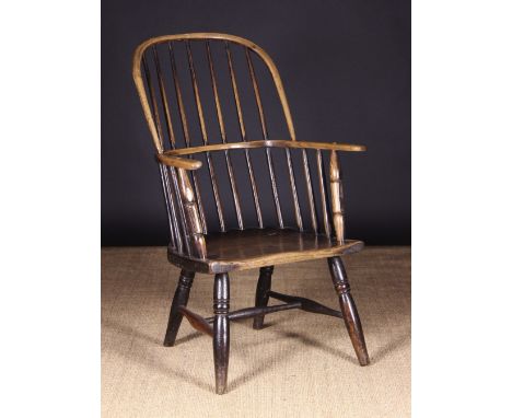 An Early 19th Century Stick Back Windsor Armchair with traces of residual paintwork, 37 ins (94 cms) high, 23 ins (59 cms) wi