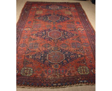 A Large Late 19th Century Soumak Carpet with four red octagons in blue ground diamond medallions on a claret field framed by 