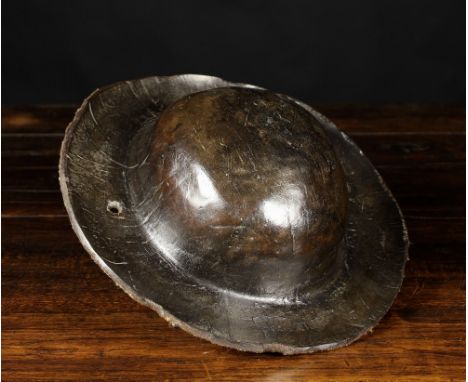 An 18th Leather Hat with domed crown and broad rim pierced by two tie holes.