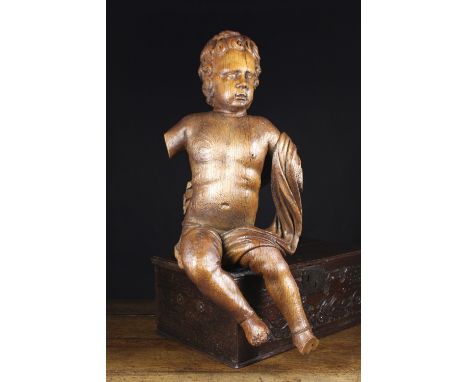 A Large Late 17th Century Flemish Carved Oak Cherub. The  figure with hollowed back carved in-perspective to be viewed elevat