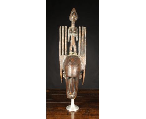 An Early 20th Century Example of a Bamana N'tomo Initiation Mask comprising of six horns and a figure with a female in the ce