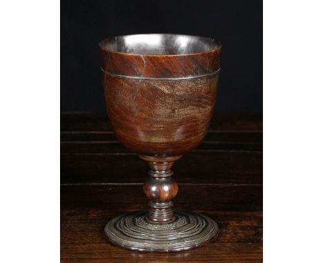 A Impressive 17th Century Treen Lignum Vitae Goblet with engine turned decoration to the foot, 9 ins (23 cms) in height.