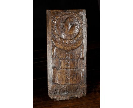 A 16th Century Oak Panel naively carved with a portrait roundel above a parchemin scroll, 16 ins x 7 ins (41 cm x 18 cms).