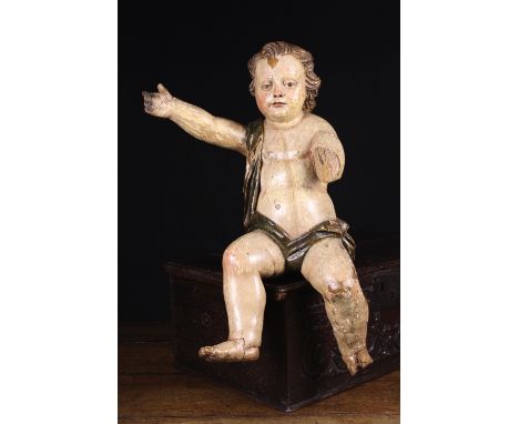 An 18th Century Polychromed Oak Carving of a Cherub depicted with wind-swept curly hair and draped sash, 24 ins (61 cms) in h