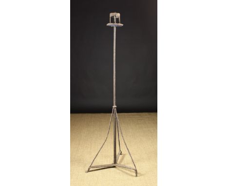 A Tall 17th/18th Century Wrought Iron Floor Standing Pricket Light. The central spike crowned with a ring strap above a round