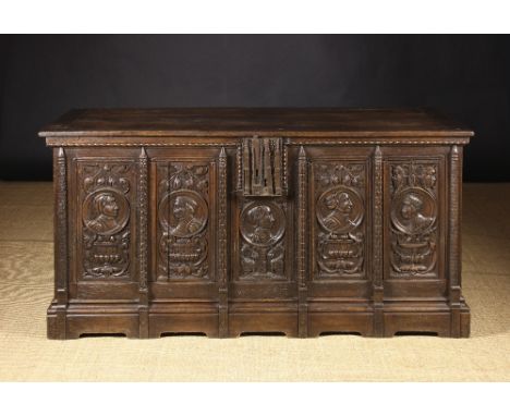 A Large 16th Century Romayne Panelled Coffer. The rectangular lid with cleated ends above twin panelled sides enriched with l