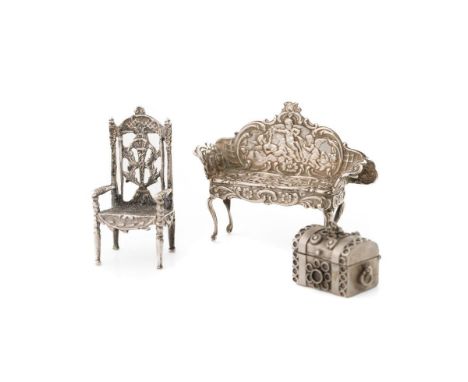 Silver miniature dolls house sofa with cherub decoration, Birmingham 1962, a silver chair and a trunk (3), 40.7 grams.  