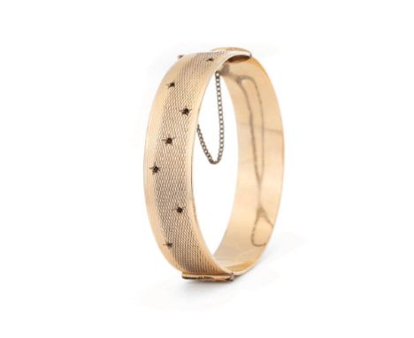 9ct gold bangle with metal core &amp; gem set decoration, stamped – 1/5th 9ct gold with metal core – Gilerco.  Gross weight 4