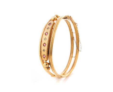 Victorian pinchbeck bangle set with 4 rubies and 3 diamond chips, 65mm diameter.  