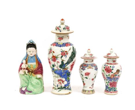 A Matched Chinese Porcelain Garniture of Three Vases and Covers, Qianlong, of baluster form, painted in famille rose enamels 