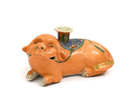 A Cantonese Porcelain Lion Dog Candlestick, 19th century, modelled recumbent with rouge de fer marking14cm longSmall filled c