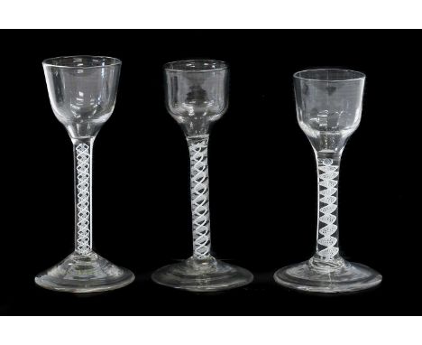 A Wine Glass, circa 1750, the ogee bowl on an opaque twist stem15cm highTwo Similar Glasses15cm and 14cm high (3)First glass 