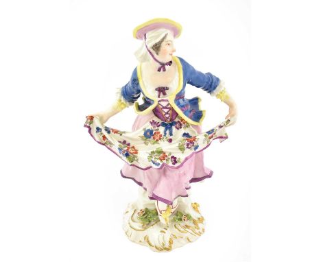 A Meissen Porcelain Figure of a Dancer, circa 1750, modelled by J.J Kandler, holding her apron out, on a scroll moulded mound