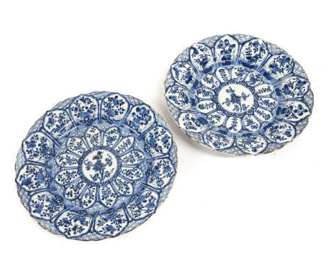 A Pair of Chinese Porcelain Dishes, Kangxi, painted in underglaze blue with a central flowerspray within two registers of lap