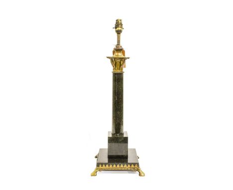 A Gilt Metal Mounted Black Marble Lamp Base, in Arts &amp; Crafts style, with leaf and flower capital, cylindrical column and