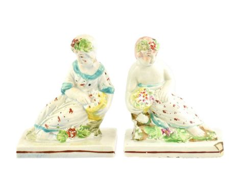 A Prattware Cradle, circa 1800, of basket moulded form containing a young girl 13cm longA Pair of Pearlware Figures of a Boy 