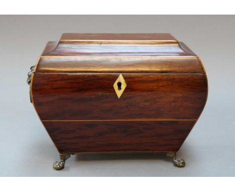 A Regency Partridge Wood Tea Caddy, of bombé form with twin ring and lion mask handles, on paw feet22cm by 13cm by 15cm
