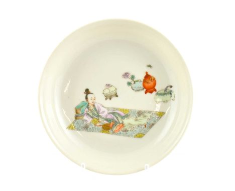 A Chinese Porcelain Saucer, Yongzheng reign mark but not of the period, painted in famille rose enamels with a maiden reclini