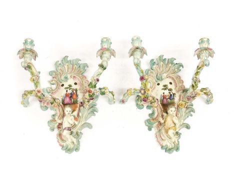 A Pair of Meissen-Style Porcelain Twin-Light Wall Sconces, circa 1900, of scroll moulded form and painted with romantic figur