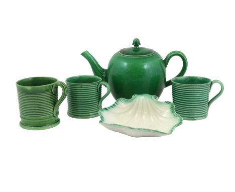 A Green-Glazed Earthenware Teapot and Cover, circa 1770, of ovoid form and with fluted spout20cm longThree Similar Ribbed Cof