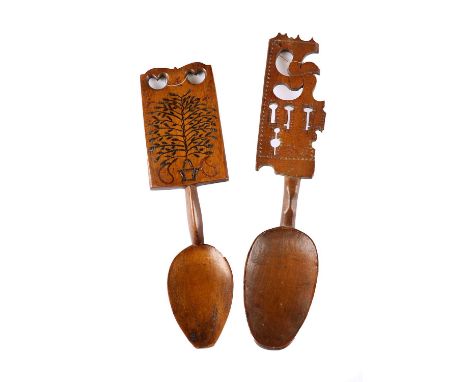 A Welsh Treen Love Spoon, 19th century, the rectangular broad handle pierced with hearts and incised and stained with a tree1