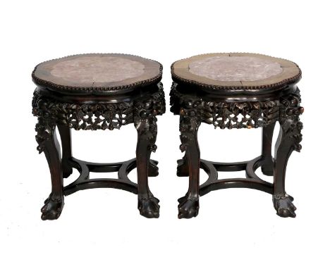 A Pair of Chinese Padouk Wood and Pink Marble Plant Stands, early 20th century, the serpentine shaped tops with beaded border