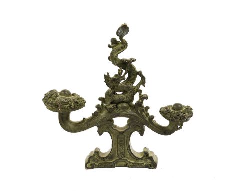 A Chinese Bronze Finial/Stand, in Archaic style, as a sinuous dragon on a scroll base29cm high