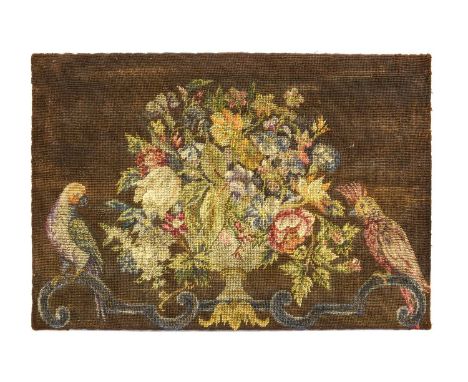 A Needlework Panel, possibly 17th century, worked in coloured wools with a vase of flowers flanked by parrots perched on scro