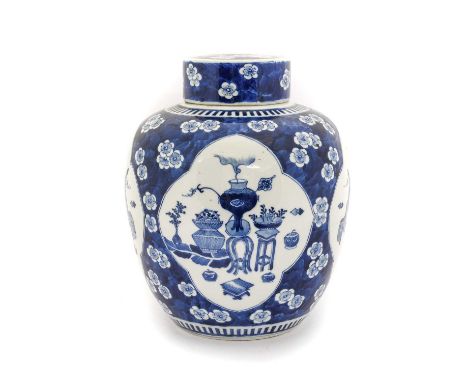 A Chinese Porcelain Jar and Cover, Kangxi reign mark, of ovoid form, painted in underglaze blue with precious objects in ogee