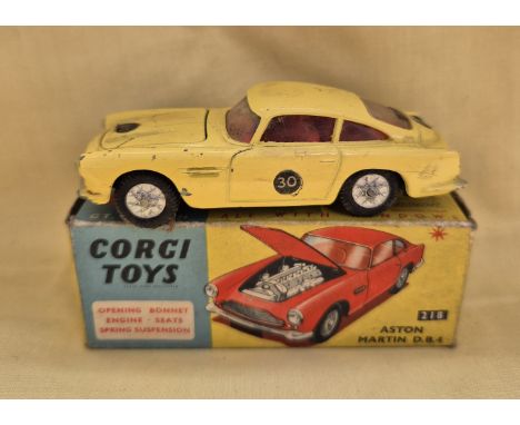 A Corgi Toys Aston Martin D.B.4 218 finished in yellow with red interior, in original box.General wear to model (some scratch