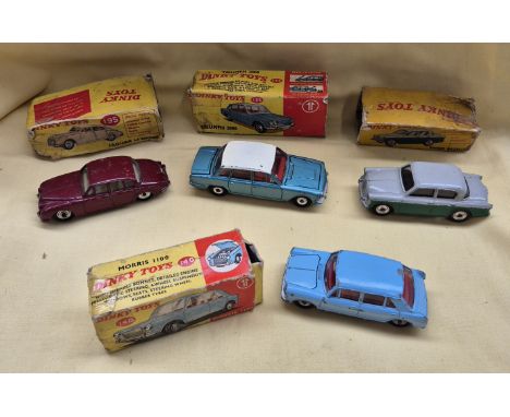 A group of four Dinky Toys die cast model vehicles  comprising of a 140 morris 1100, a 135 triumph 2000, a 168 singer gazelle