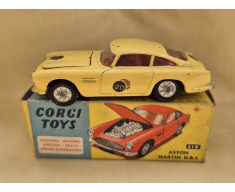 A Corgi Toys Aston Martin D.B.4 218 finished in yellow with red interior, in original box.General wear to model (some scratch