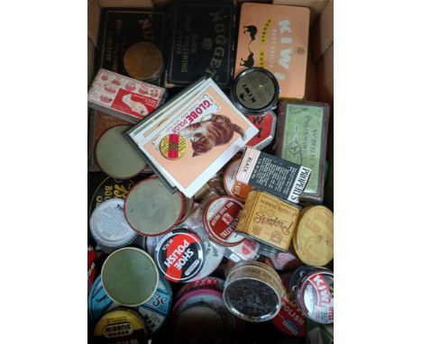 A box of assorted vintage shoe polish tins.