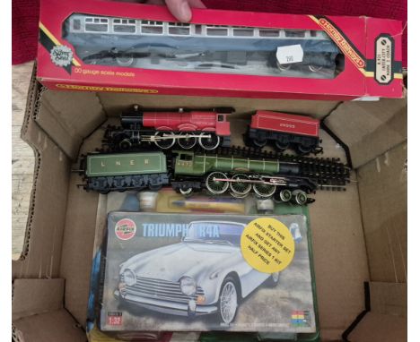 A box containing 2 Hornby 00 Gauge locomotives with tenders, boxed Hornby coach &amp; an Airfix starter kit Triumph TR4A.