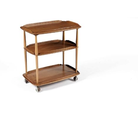 Lucian Ercolani for Ercol: an elm Windsor model No 458 elm three-tier drinks trolley, the moulded rectangular tops on taperin