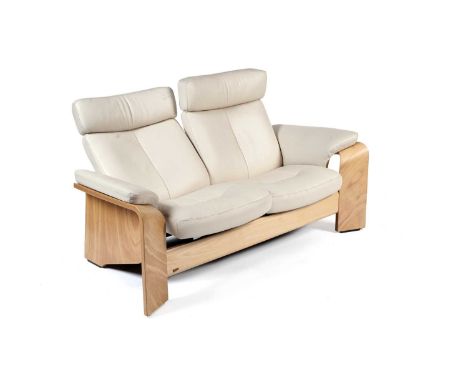 Ekornes Stressless - Pegasus: A modern two seater reclining sofa, upholstered in cream leather, raised on a light maple bentw