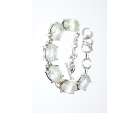 Silver bracelet with light green gem stones