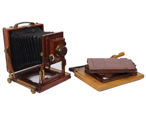 A Thornton Pickard mahogany cased camera with a F7.7 lens along with three dark slides and a wooden guillotine