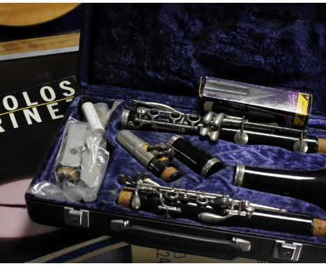 A cased Boosey and Hawkes clarinet, together with a collection of clarinet sheet music. 