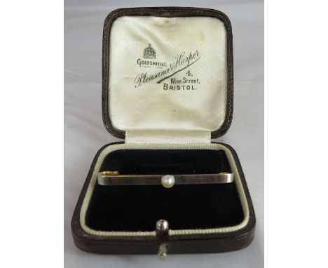 A button pearl bar brooch, the pearl (untested and unwarranted) approximately 4 mm diameter, on a white fronted yellow bar 4.