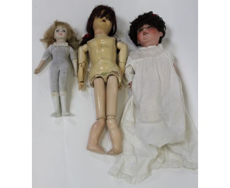A large German doll with a ceramic head along with a wooden bodied doll and one other