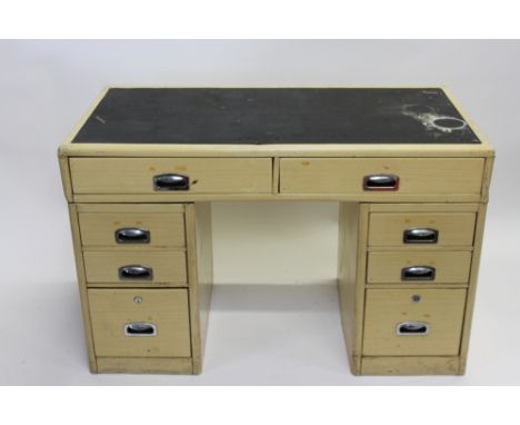 A 20th century metal industrial twin pedestal desk with a rubber insert, two fitted long drawers and six short drawers, 78cm 