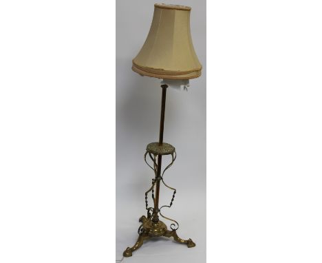 An early 20th century Arts & Crafts brass standard lamp, with shade, 134.5cm high