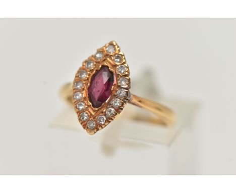 AN 18CT GOLD RUBY AND DIAMOND RING, a marquise cut ruby prong set in yellow gold, set with a surround of single cut diamonds,