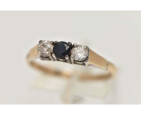 A SILVER GILT THREE STONE RING, set with a central circular cut blue sapphire, flanked with two colourless cubic zirconia, ea