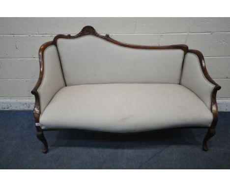 A VICTORIAN MAHOGANY SOFA, one side of backrest higher than the other, with a scrolled crest, closed armrests, on front cabri