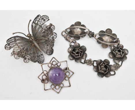 THREE ITEMS OF WHITE METAL JEWELLERY, to include a white metal flower bracelet, stamped 'Sterling, Corcraft' a white metal fi