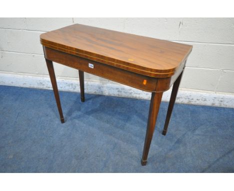 A GEORGIAN MAHOGANY FOLD OVER CARD TABLE, the top enclosing a green baize playing field, raised on square tapered legs and sp