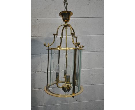 A 20TH CENTURY BRASS CYLINDRICAL HALL LANTERN, the glass panes encasing a four branch light fitting, diameter 33cm x height t