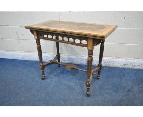 AN EDWARDIAN BURR WALNUT FOLD OVER CARD TABLE, the swivel top enclosing a green baize playing field and a storage compartment